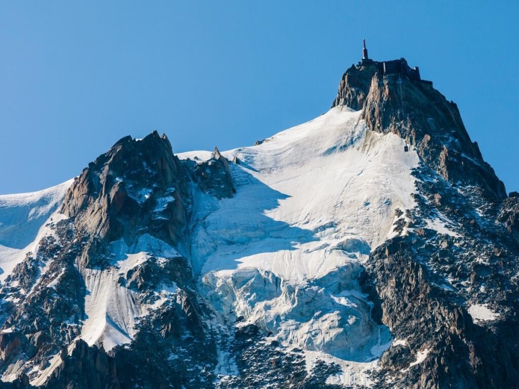 Panoramic view from the Aiguille du Midi summit overlooking glaciers and Alpine peaks