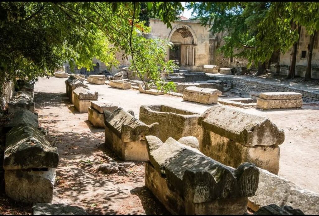 Tree-lined avenue and ancient sarcophagi at Alyscamps in Arles