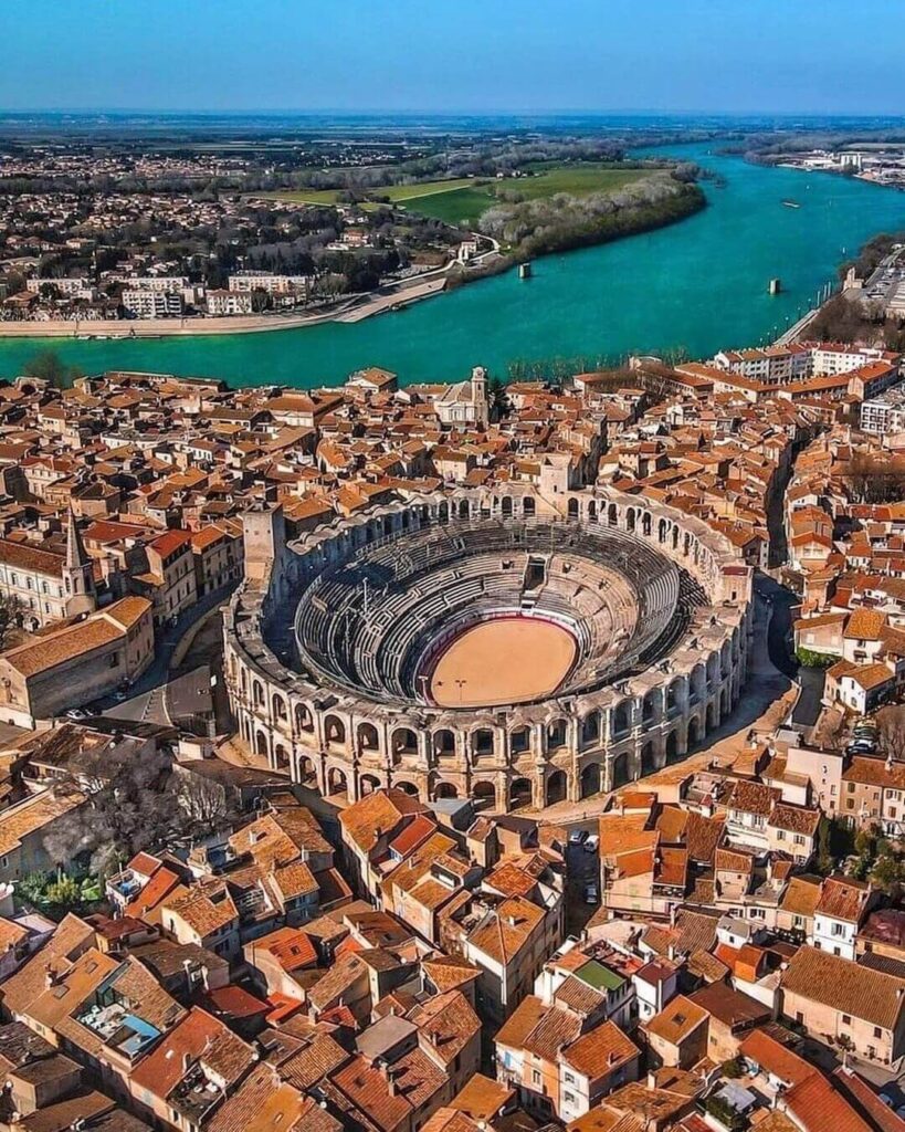 Arles Amphitheater illuminated during golden hour in Provence