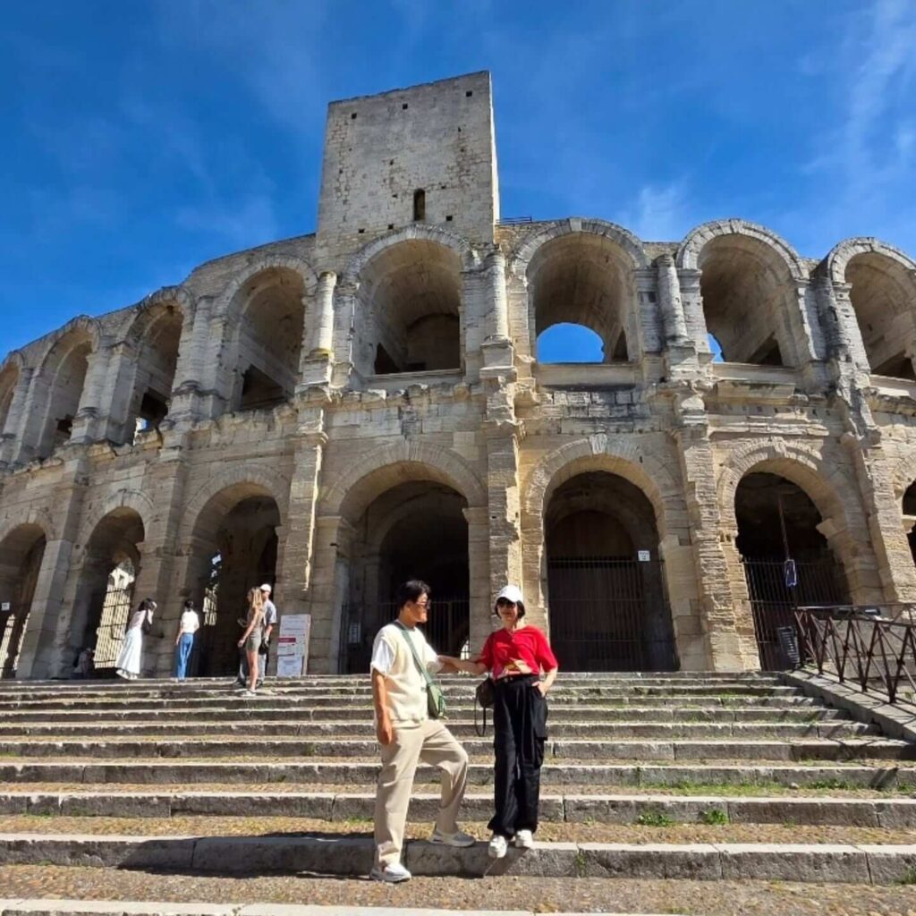 Visitors exploring the historic center of Arles on foot