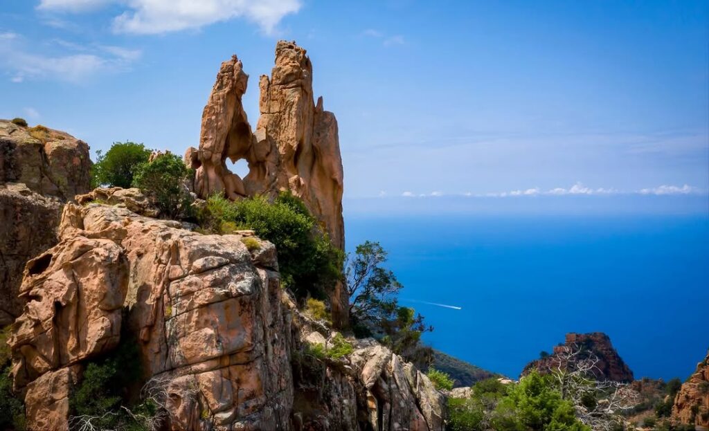 Red granite cliffs and coastal scenery in the Calanques de Piana, Corsica