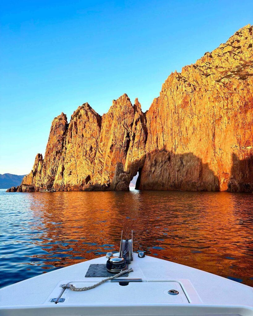 Red granite cliffs of the Calanques de Piana viewed from the Mediterranean Sea
