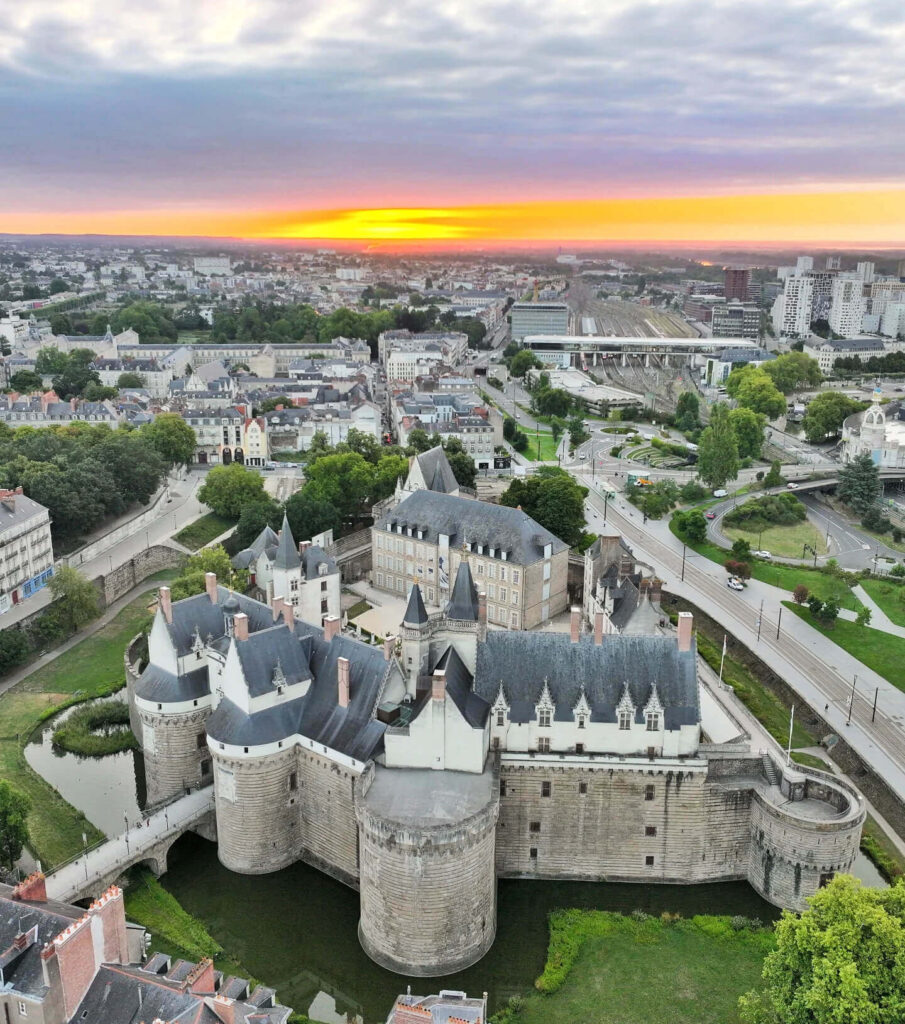 Exterior of Château des ducs de Bretagne in Nantes with medieval walls, towers, and moat