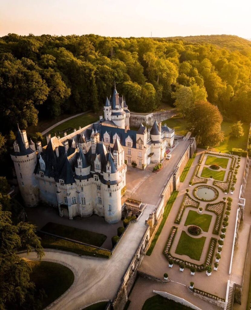 Château d'Ussé viewed from the gardens with its fairy-tale towers rising above the trees