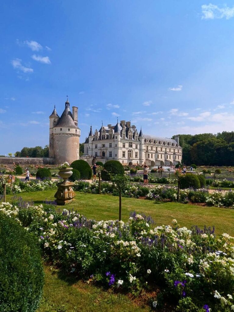 Visitors walking through the gardens of Château de Chenonceau