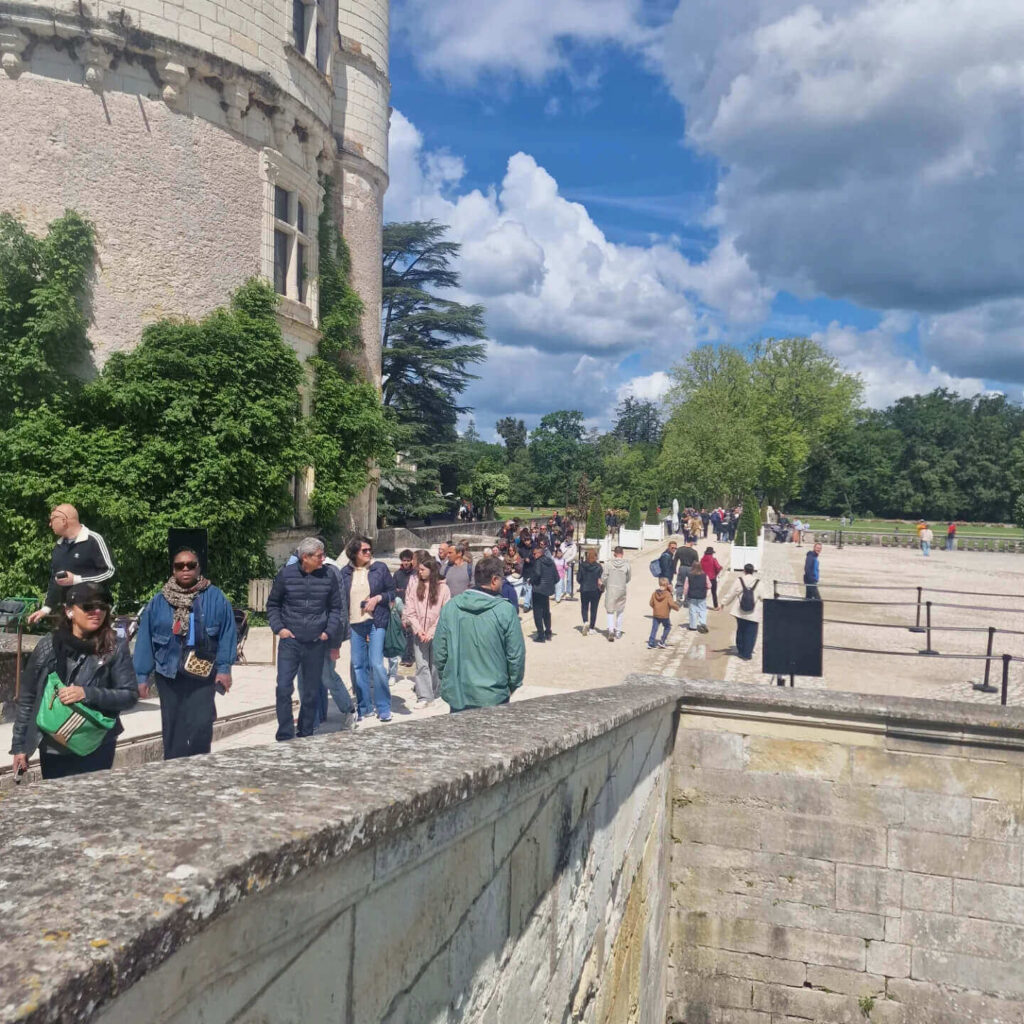 Visitors exploring Château de Chenonceau in summer