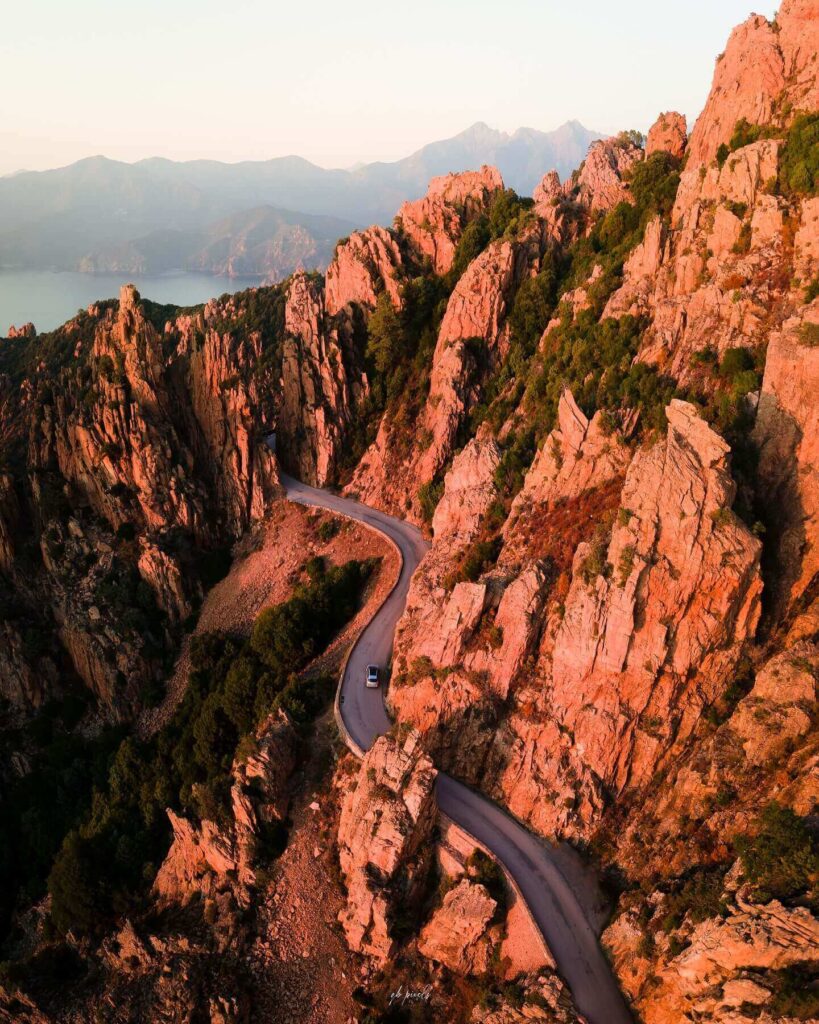 Scenic drive through the red rock formations of the Calanques de Piana