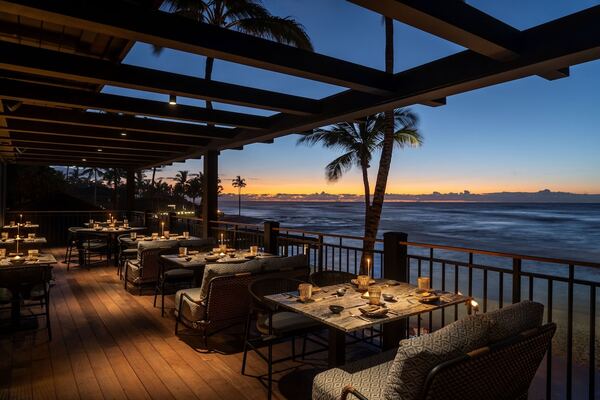 Luxury oceanfront view of Four Seasons Resort Hualalai on Hawaii's Big Island, featuring palm-lined pools, elegant accommodations, lava rock landscapes, and stunning Pacific Ocean scenery.