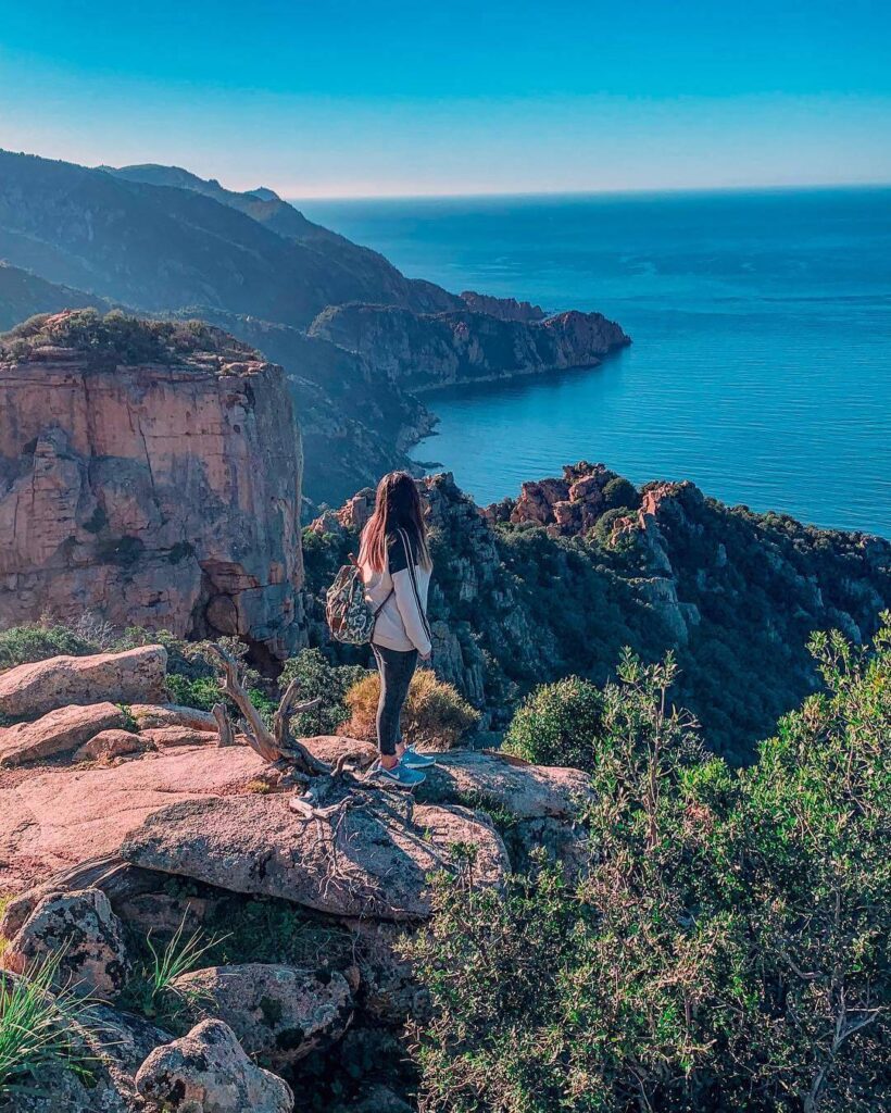 Rocky hiking trail in the Calanques de Piana with red granite formations