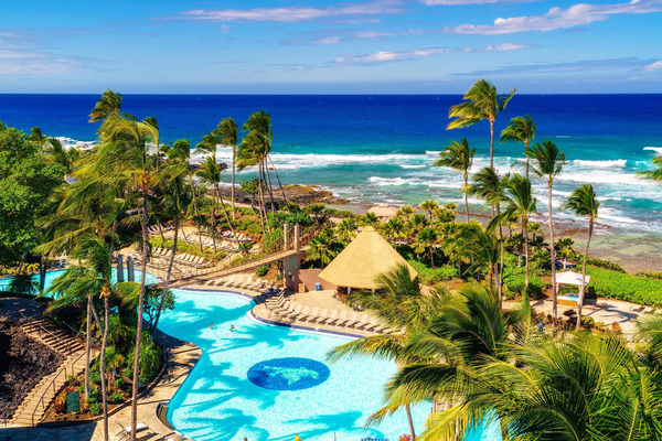 Expansive view of Hilton Waikoloa Village on Hawaii's Big Island, showcasing oceanfront pools, tropical lagoons, palm-lined pathways, family-friendly amenities, and stunning coastal scenery.