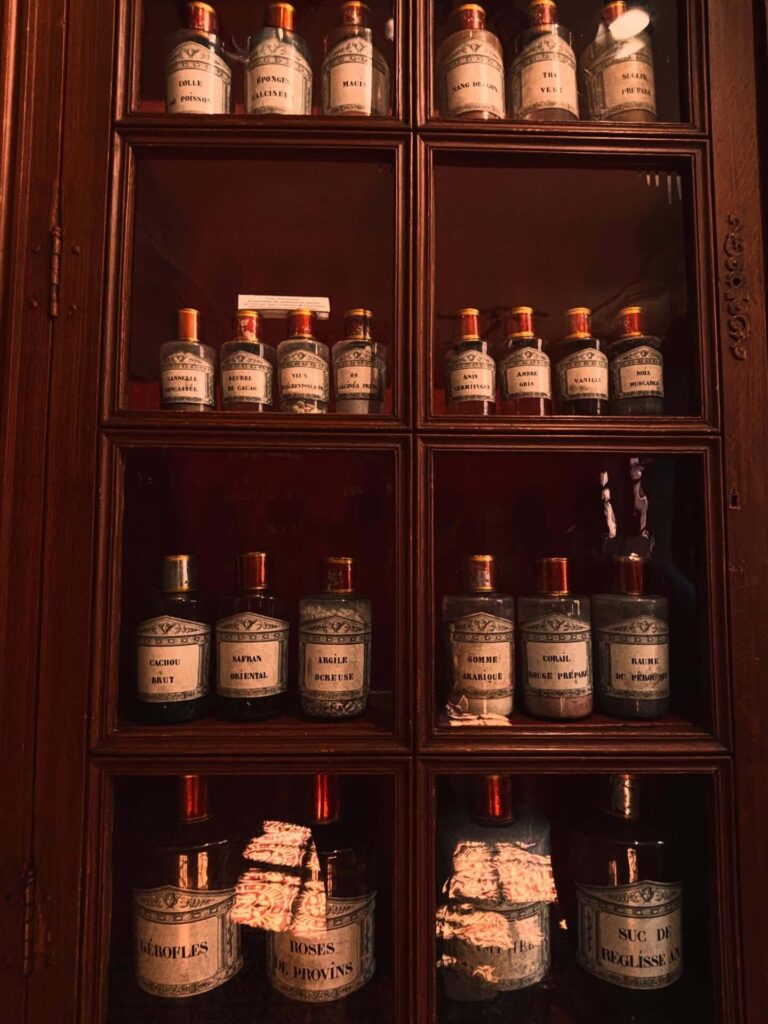 Historic pharmacy at Hospices de Beaune featuring ceramic medicine jars