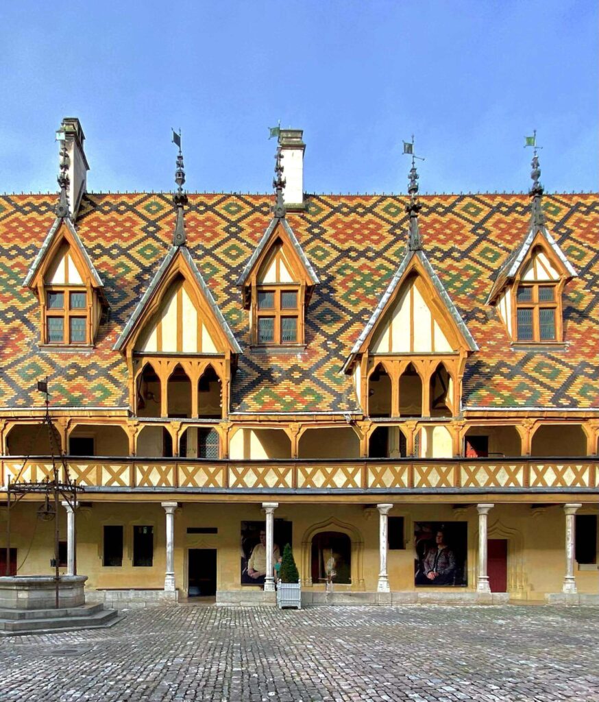 Hospices de Beaune featuring colorful tiled roofs and Gothic architecture in Burgundy