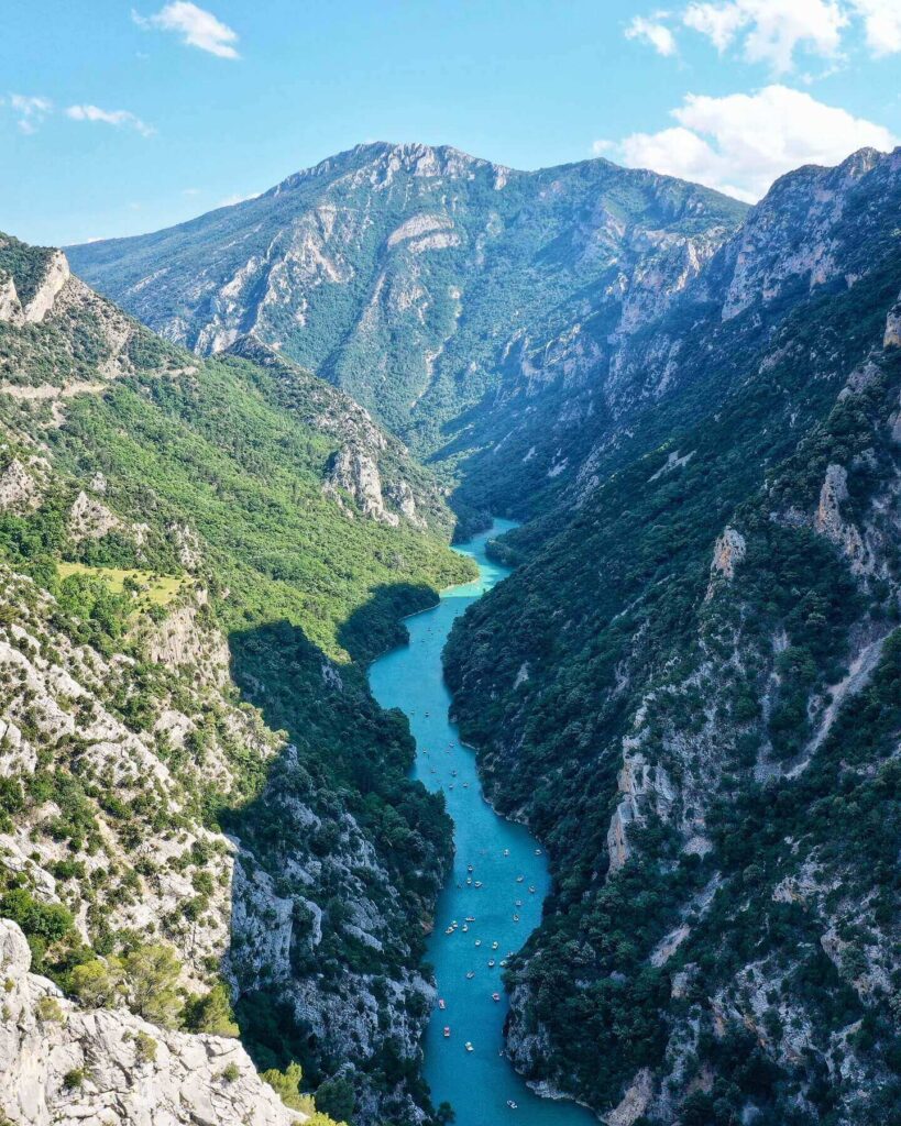 Visitors kayaking through the narrow canyon of Gorges du Verdon