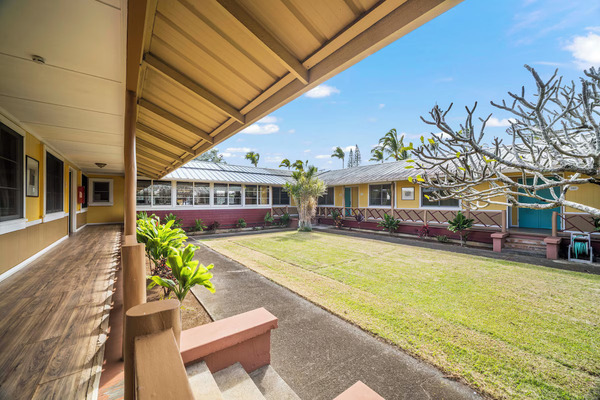 Charming exterior of Kohala Village Inn on Hawaii's Big Island, featuring cozy boutique accommodations, tropical landscaping, local island character, and a peaceful small-town Hawaiian atmosphere.