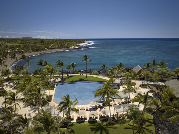 Luxury beachfront setting at Kona Village, A Rosewood Resort on Hawaii's Big Island, featuring traditional hale-inspired accommodations, pristine shoreline, lush tropical landscapes, and a serene island retreat atmosphere.