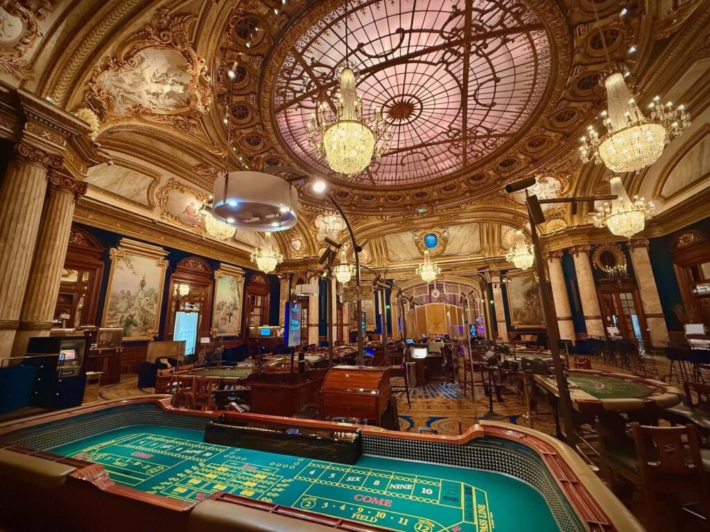 Ornate interior architecture inside Monte Carlo Casino with chandeliers and marble details