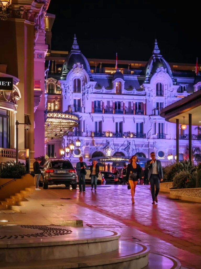 Guests dressed in elegant evening attire outside Monte Carlo Casino