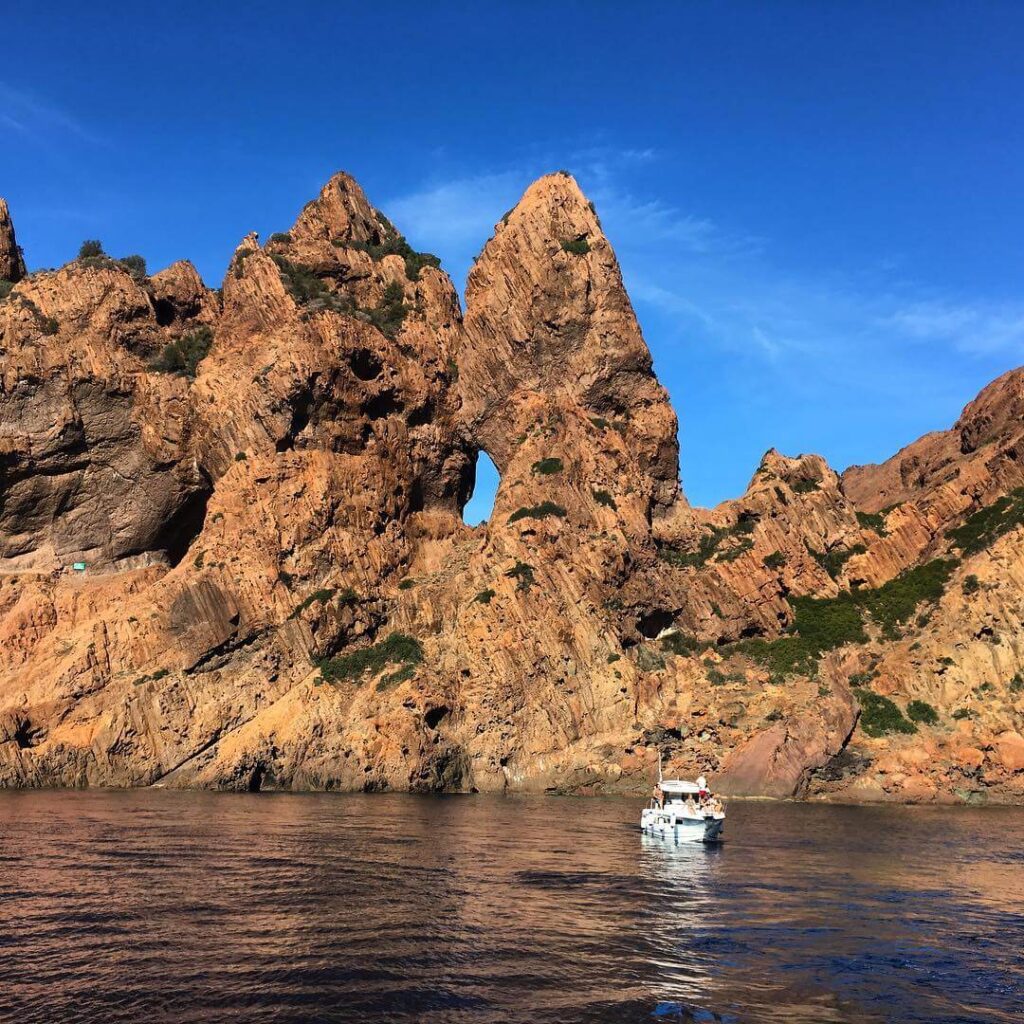 Morning boat tour passing the red cliffs of Scandola Nature Reserve