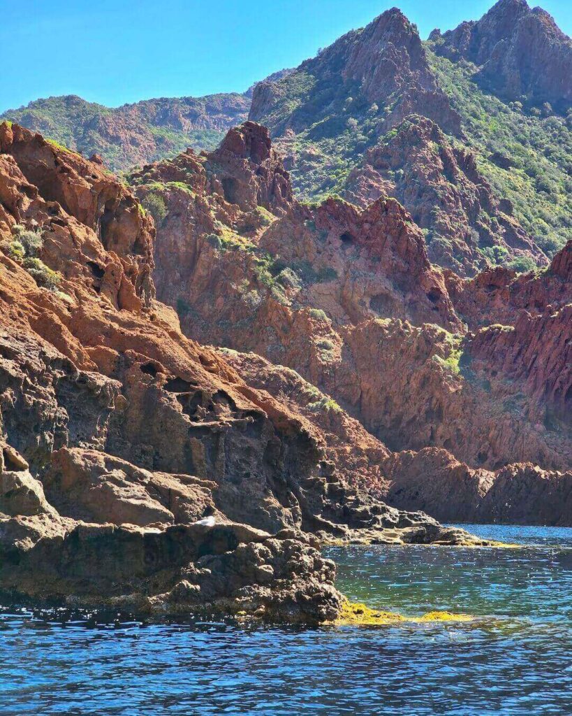 Panoramic view of Scandola Nature Reserve's volcanic coastline and turquoise water