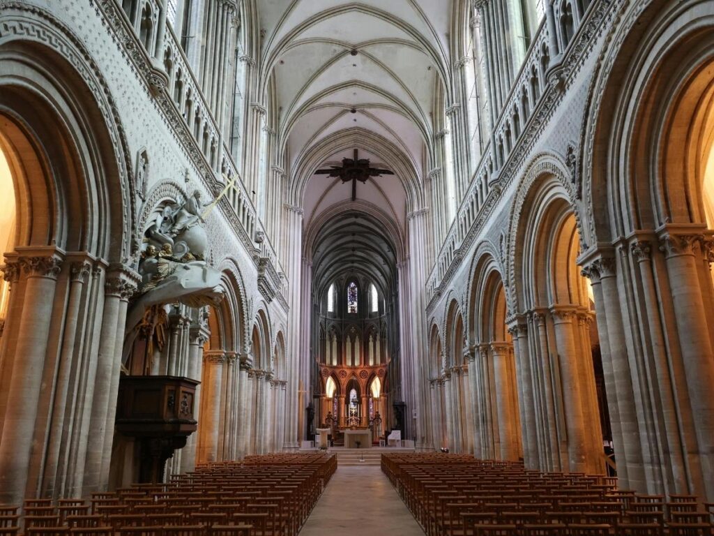 The grand nave of Strasbourg Cathedral with vaulted ceilings and stone pillars