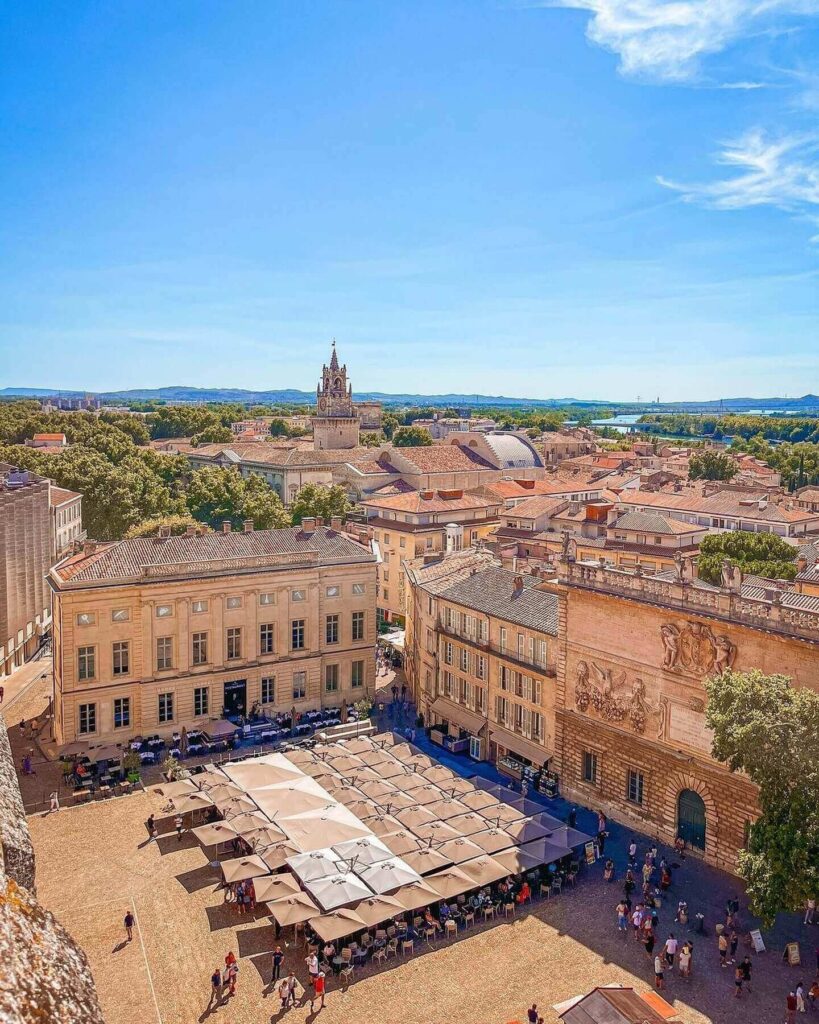 Outdoor cafés and historic buildings at Place de l'Horloge in Avignon