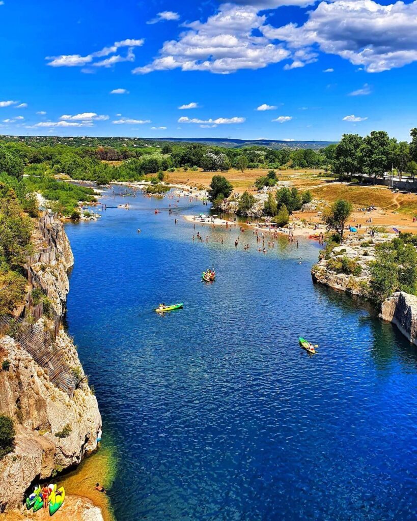 Visitors kayaking beneath Pont du Gard in southern France