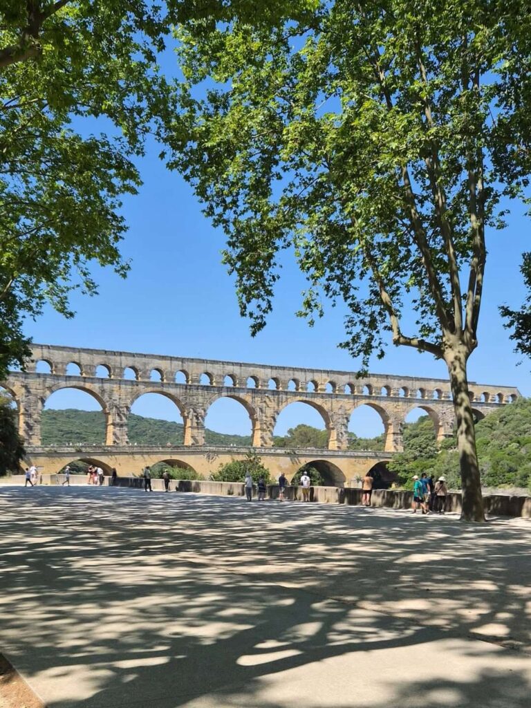 Visitors exploring Pont du Gard during a day trip