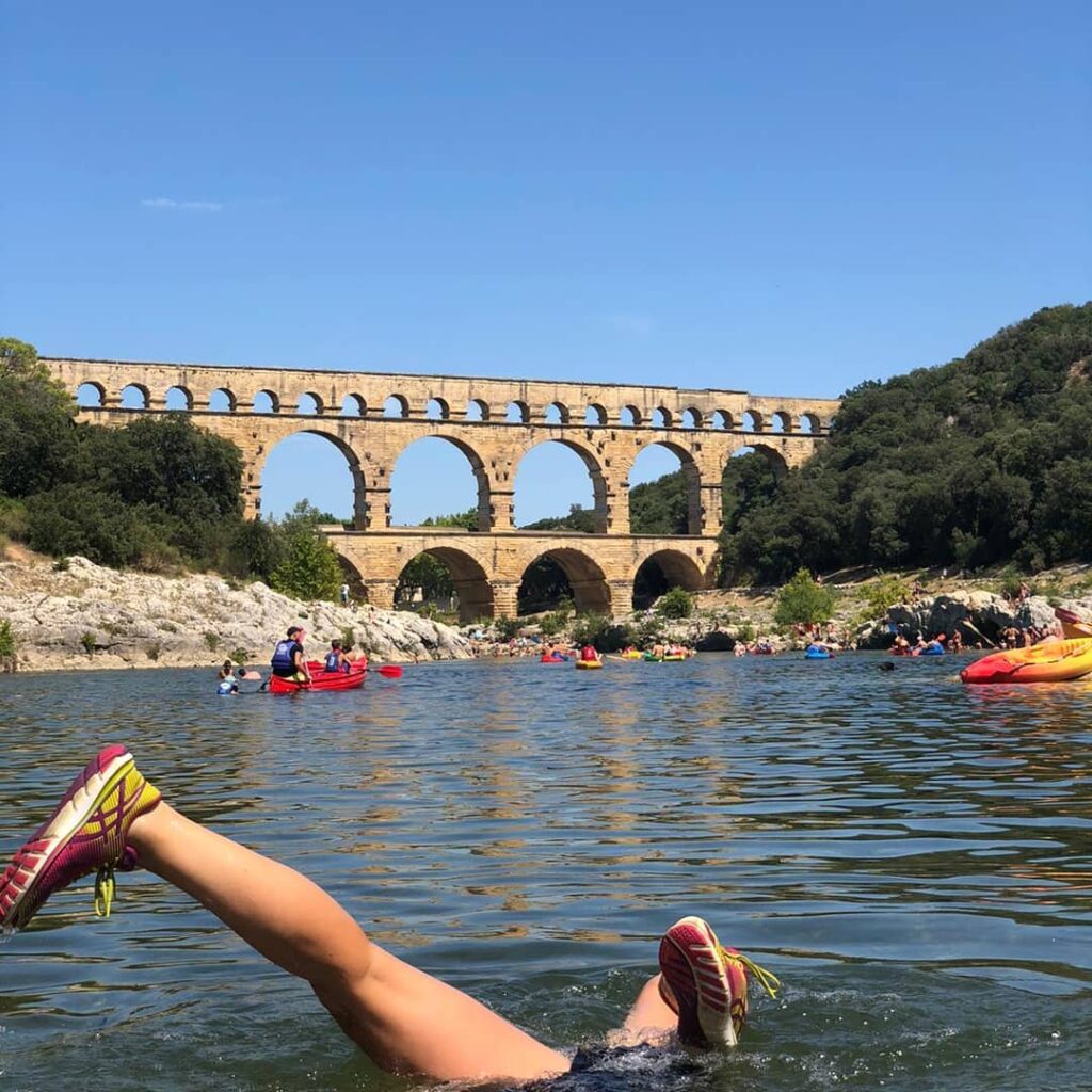 Visitors kayaking toward Pont du Gard in southern France