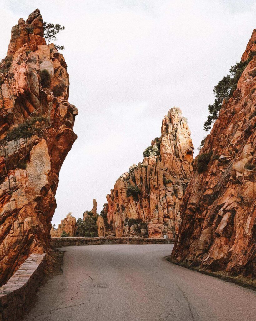 Scenic drive through the red granite cliffs of the Calanques de Piana