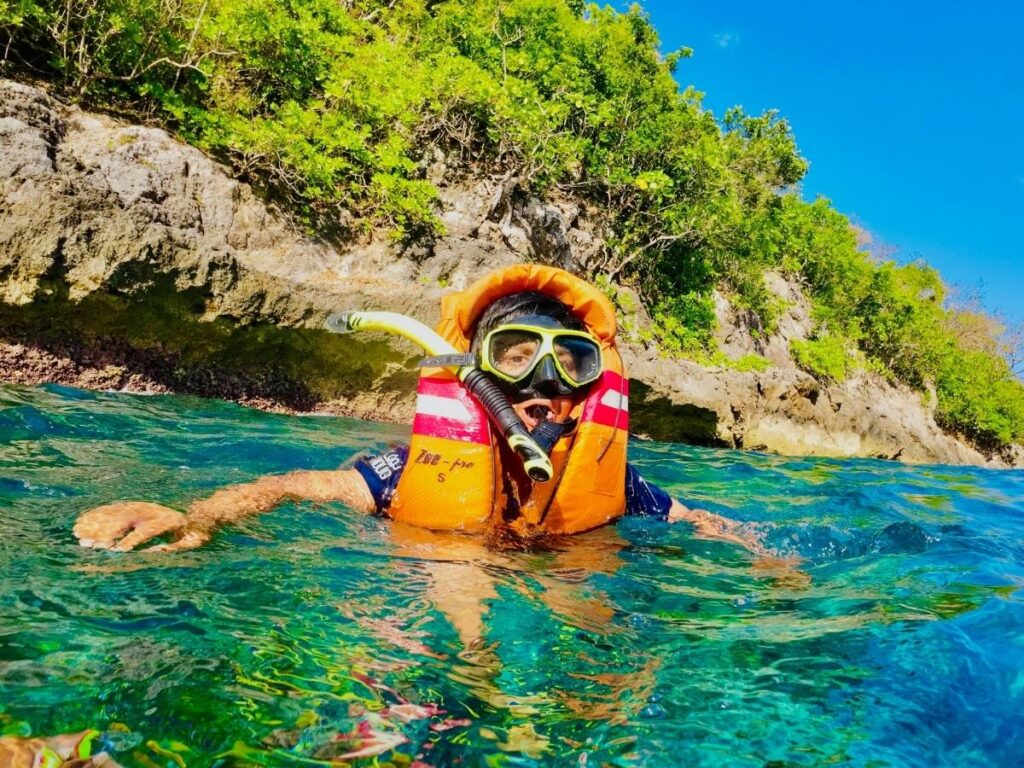 Snorkelers exploring the crystal-clear waters near Scandola Nature Reserve