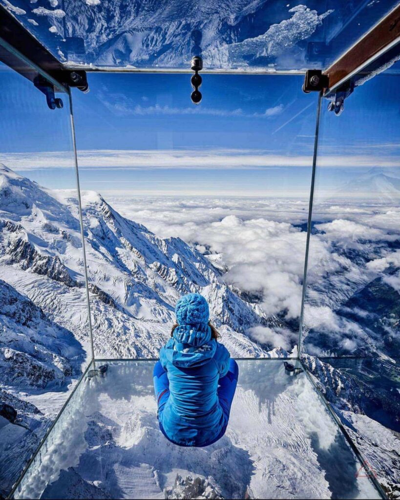 Visitors inside the Step Into the Void glass skybox at Aiguille du Midi
