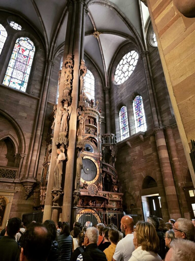 Visitors watching the astronomical clock demonstration at Strasbourg Cathedral