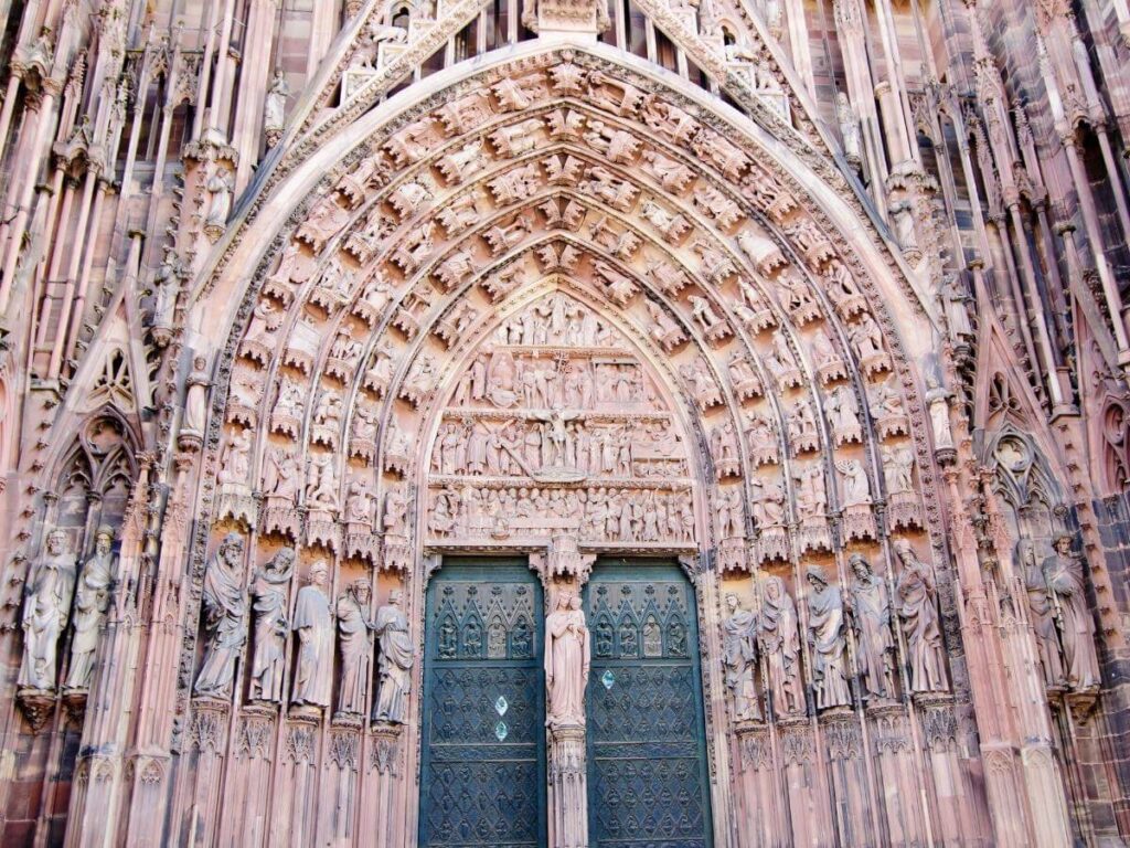 West facade of Strasbourg Cathedral covered in Gothic sculptures and carvings