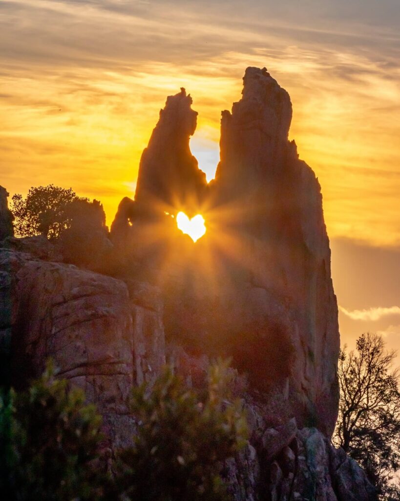 Sunset illuminating the red granite cliffs of the Calanques de Piana