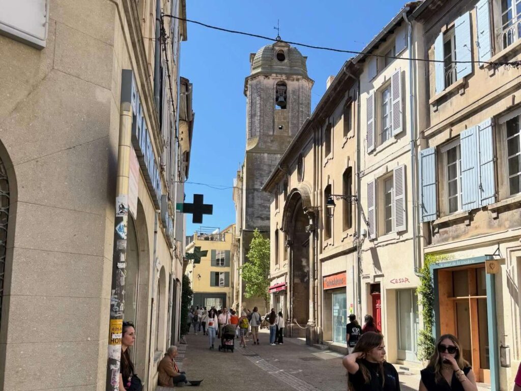 Visitors exploring Roman monuments in Arles on foot