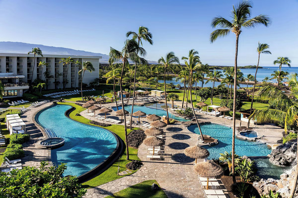Scenic view of Waikoloa Beach Marriott Resort & Spa on the Kohala Coast, featuring oceanfront pools, lush tropical gardens, palm trees, and family-friendly amenities offering excellent value for a Hawaiian vacation.