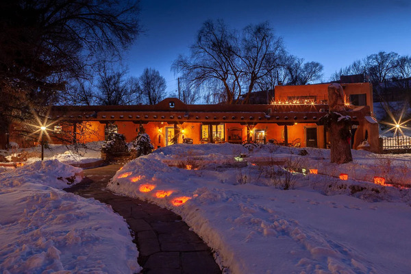 Exterior view of Adobe & Pines Inn featuring traditional adobe architecture surrounded by scenic landscapes.