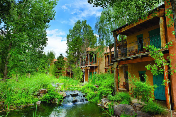 Grand entrance of El Monte Sagrado Living Resort & Spa with elegant adobe-inspired design and welcoming atmosphere.