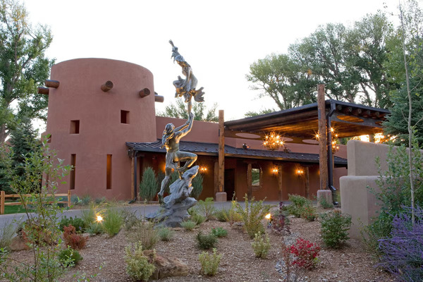 Spacious luxury suite at El Monte Sagrado Living Resort & Spa with modern furnishings and cozy fireplace.