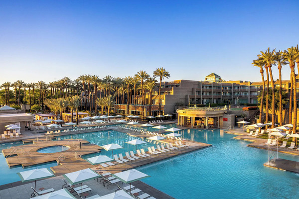 Resort-style swimming pool with waterfalls and private cabanas at Grand Hyatt Scottsdale Resort