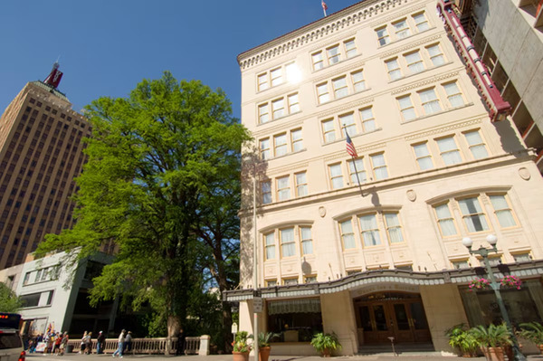 Exterior view of Drury Inn & Suites San Antonio Riverwalk, featuring a modern hotel facade, comfortable accommodations, and a convenient downtown location near the San Antonio River Walk.