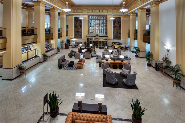 Exterior view of Drury Plaza Hotel San Antonio Riverwalk, featuring its historic high-rise architecture, elegant facade, and convenient location overlooking the San Antonio River Walk in downtown San Antonio.