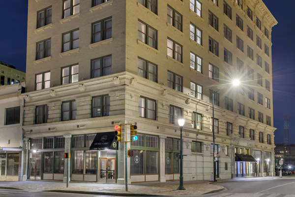 Exterior view of Hotel Gibbs Downtown San Antonio Riverwalk, featuring historic architecture, a distinctive facade, and a convenient location near the Alamo and San Antonio River Walk.