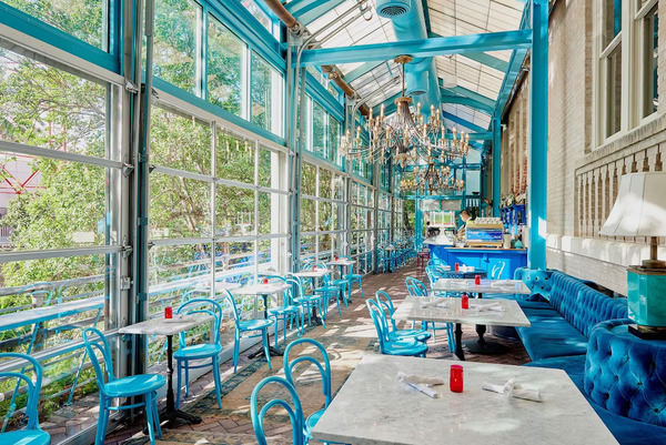 Exterior view of Hotel Havana in San Antonio, featuring Mediterranean-inspired architecture, tropical landscaping, and a distinctive boutique hotel atmosphere along the San Antonio River Walk.