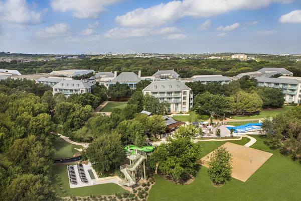 Exterior view of Hyatt Regency Hill Country Resort and Villas in San Antonio, featuring its ranch-inspired architecture, lush landscaped grounds, resort-style amenities, and scenic Texas Hill Country surroundings.