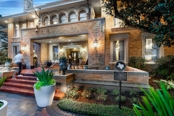 Exterior view of La Colombe d'Or Hotel in Houston, showcasing its historic mansion architecture, luxury boutique accommodations, lush gardens, and elegant atmosphere in the Montrose neighborhood.
