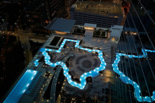 Exterior view of Marriott Marquis Houston, a luxury downtown hotel featuring modern architecture, upscale accommodations, a rooftop pool, and premium amenities near Houston's top attractions.