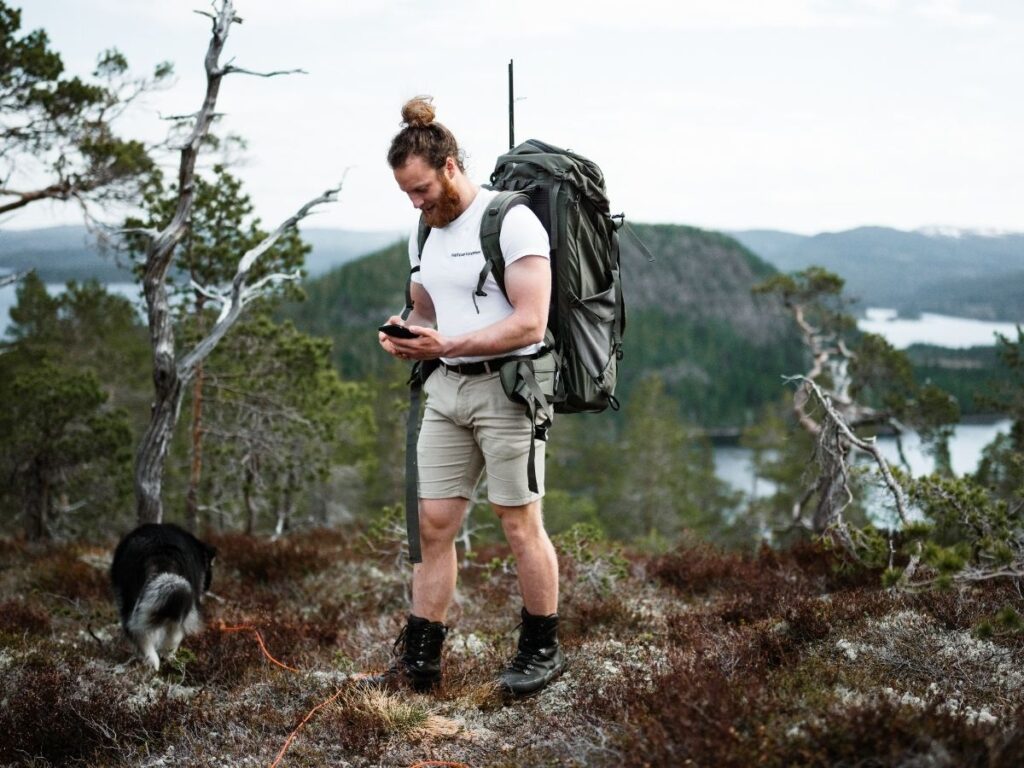 Hiker carrying water and hiking gear on a trail in Mercantour National Park