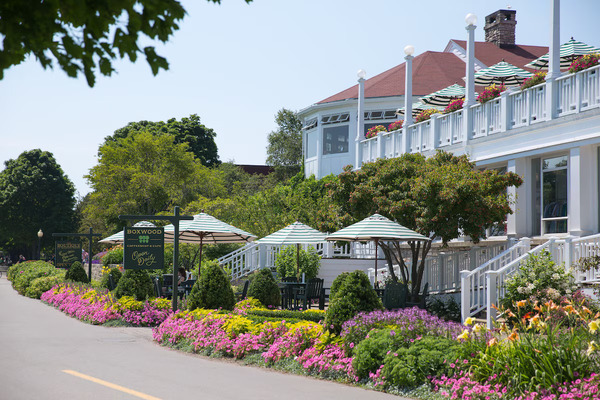 Mission Point Resort on Mackinac Island featuring waterfront accommodations, expansive green lawns, outdoor seating areas, and stunning views of Lake Huron.