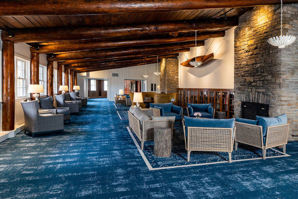 Mission Point Resort on Mackinac Island featuring waterfront views, spacious lawns, Adirondack chairs, and elegant resort accommodations overlooking Lake Huron.